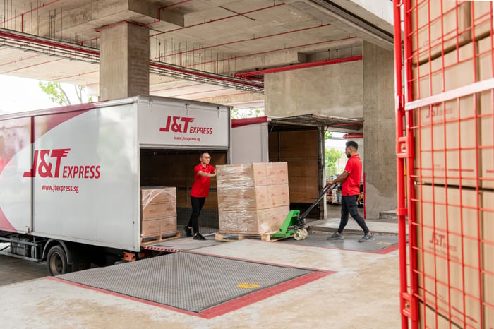 J&T workers unloading goods from truck.